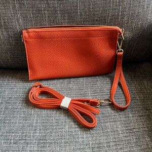 Crossbody wristlet in orange